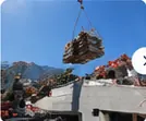 Grutage de palettes de matériaux sur une toiture